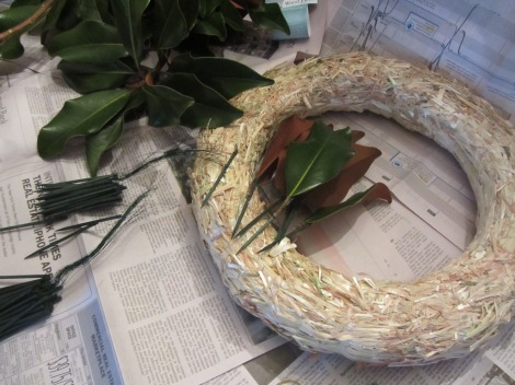 I like to use a straw wreath form, also available in craft stores.  Wind up a dozen or so leaves before you begin.