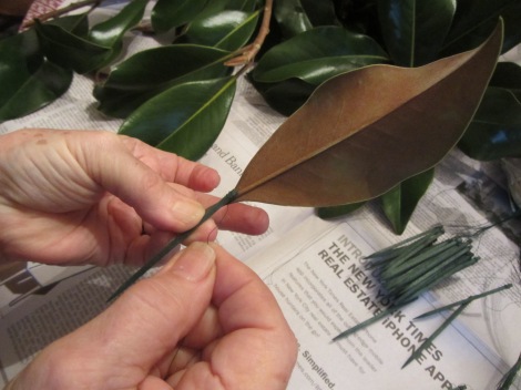 Pick off leaves (I choose medium sized ones) and using wired floral picks, wind each stem with the wire.  After a few leaves you get the feel for it and can twirl the pick, winding it quickly and easily.  These picks are available in craft stores.